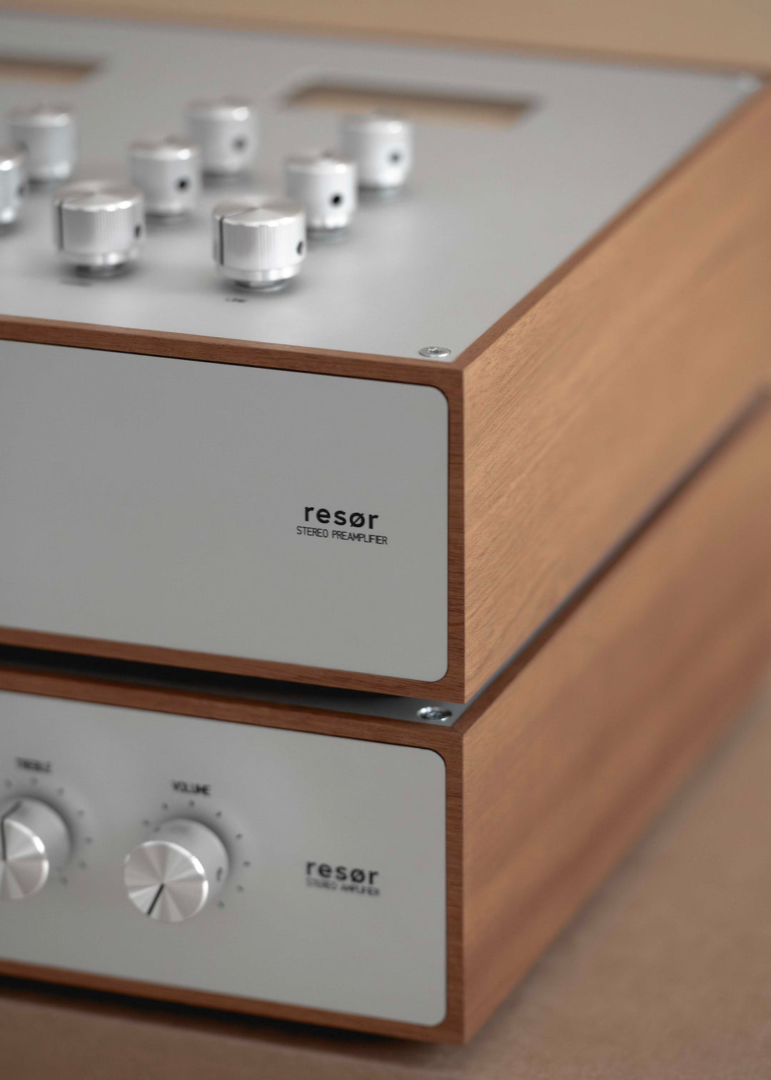 Audio equipment with wooden casing and silver knobs on a beige background