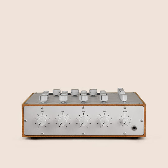 Audio mixer console with knobs and dials on a beige background