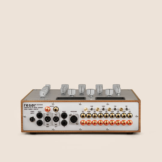 Audio equipment with control knobs and buttons on a beige background
